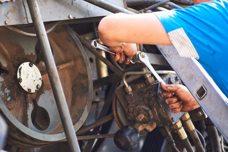 Technician servicing a tractor